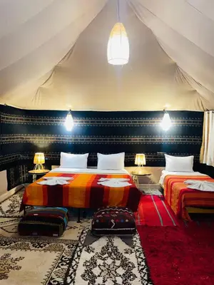 a bedroom with two beds in a tent at Glance over nights at luxury in Merzouga