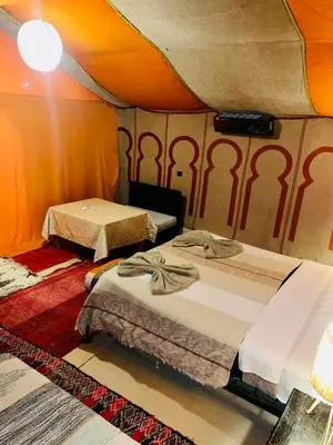 a room with two beds in a tent at Glance over nights at luxury in Merzouga