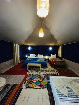 a bedroom with a bed in a tent at Glance over nights at luxury in Merzouga