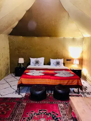 a bedroom with a large bed in a tent at Glance over nights at luxury in Merzouga