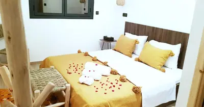 a bedroom with a bed with red hearts on it at Dar Yan in Er Rachidia