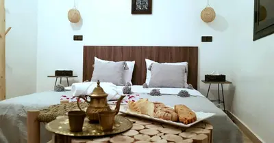 a bed with a tray of bread and pastries on it at Dar Yan in Er Rachidia