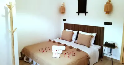a bedroom with a bed with flowers on it at Dar Yan in Er Rachidia