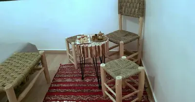 a small table and two stools in a room at Dar Yan in Er Rachidia