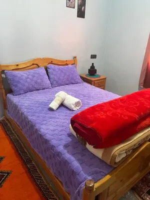 a bedroom with a purple bed with two pillows at Espace Taznakhte in Tazenakht