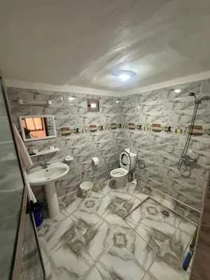 a bathroom with a sink and a toilet at Espace Taznakhte in Tazenakht