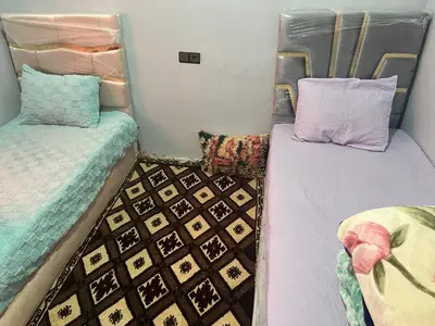 a room with two twin beds in a room at Espace Taznakhte in Tazenakht