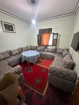 a living room with a couch and a table at Espace Taznakhte in Tazenakht
