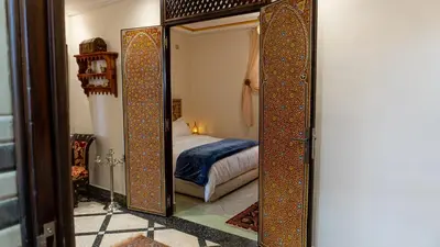 a mirror in a room with a bed at Dar Bouzoubaa in Fès