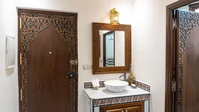 a bathroom with a sink and a mirror at Dar Bouzoubaa in Fès