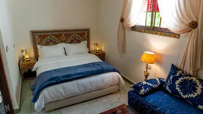 a bedroom with a bed and a couch at Dar Bouzoubaa in Fès