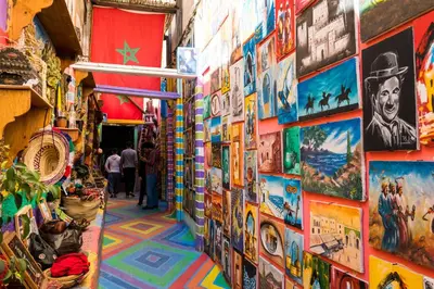 a street with paintings and pictures on the wall at Dar Bouzoubaa in Fès