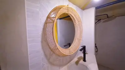 a mirror on a wall in a bathroom at Horaz Merzouga Camp in Merzouga